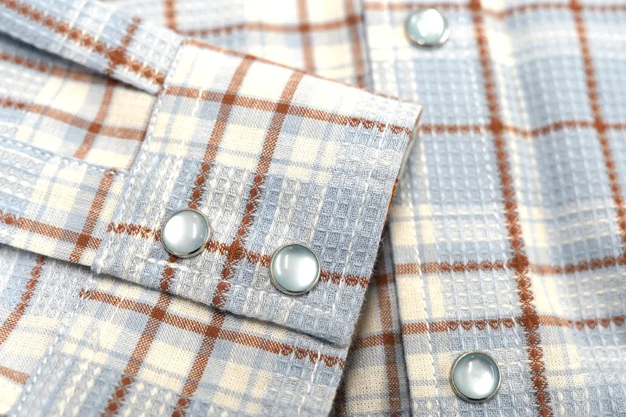 Close-up of a Journal Western shirt focusing on the heavy-duty snap buttons.