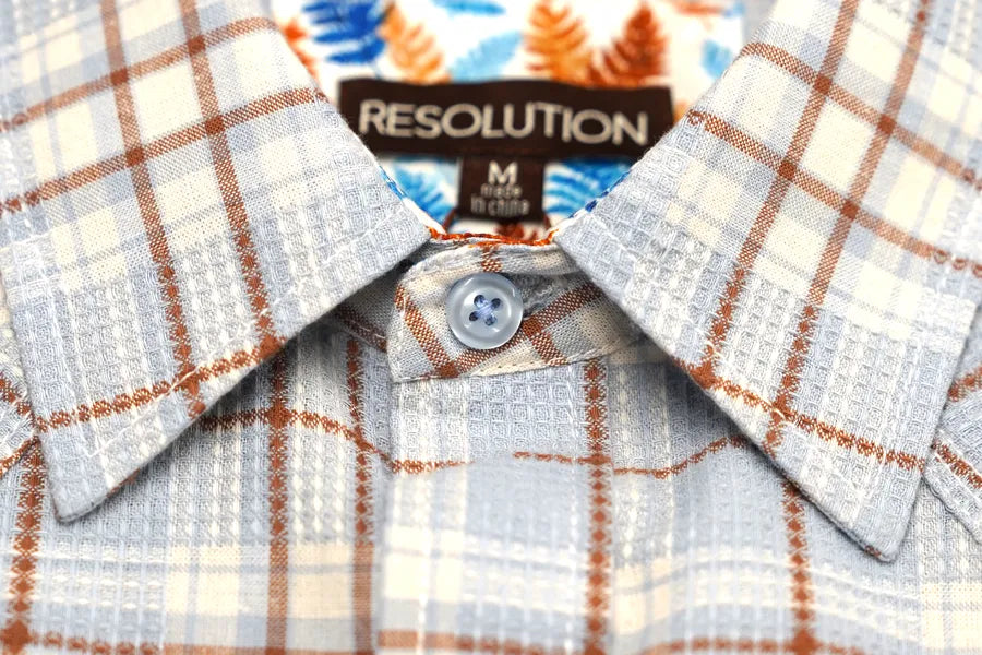 Close-up of a Journal Western snap shirt collar and button on a comfort fit garment.